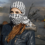A Palestinian student from Birzeit University, her face covered with the traditional keffiyeh, pictured during clashes between students and Israeli troops. (Photo: Abbas Momani/AFP/Getty Images)
