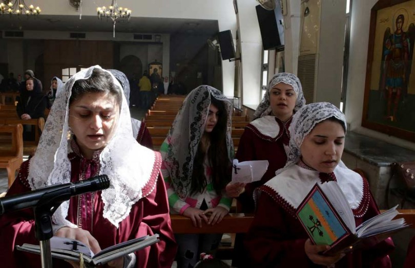Displaced Assyrian women who fled their hometowns due to ISIS pray at the Ibrahim-al Khalil Melkite Greek Catholic church near Damascus (Photo: LOUAI BESHARA/AFP/Getty Images)