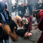 A woman helps another woman feeling as Turkish anti-riot police officers use tear gas to disperse supporters in front of Zaman headquarters.(Photo: OZAN KOSE/AFP/Getty Images)