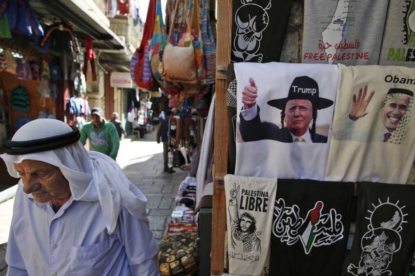 A Palestinian walks past a souvenir shop displaying T-shirts bearing images of US President Barack Obama wearing a kaffiyeh and president-elect Donald Trump dressed as a Hasidic Jew in Jerusalem's Old City November 10, 2016. (Photo: AHMAD GHARABLI/AFP/Getty Images)